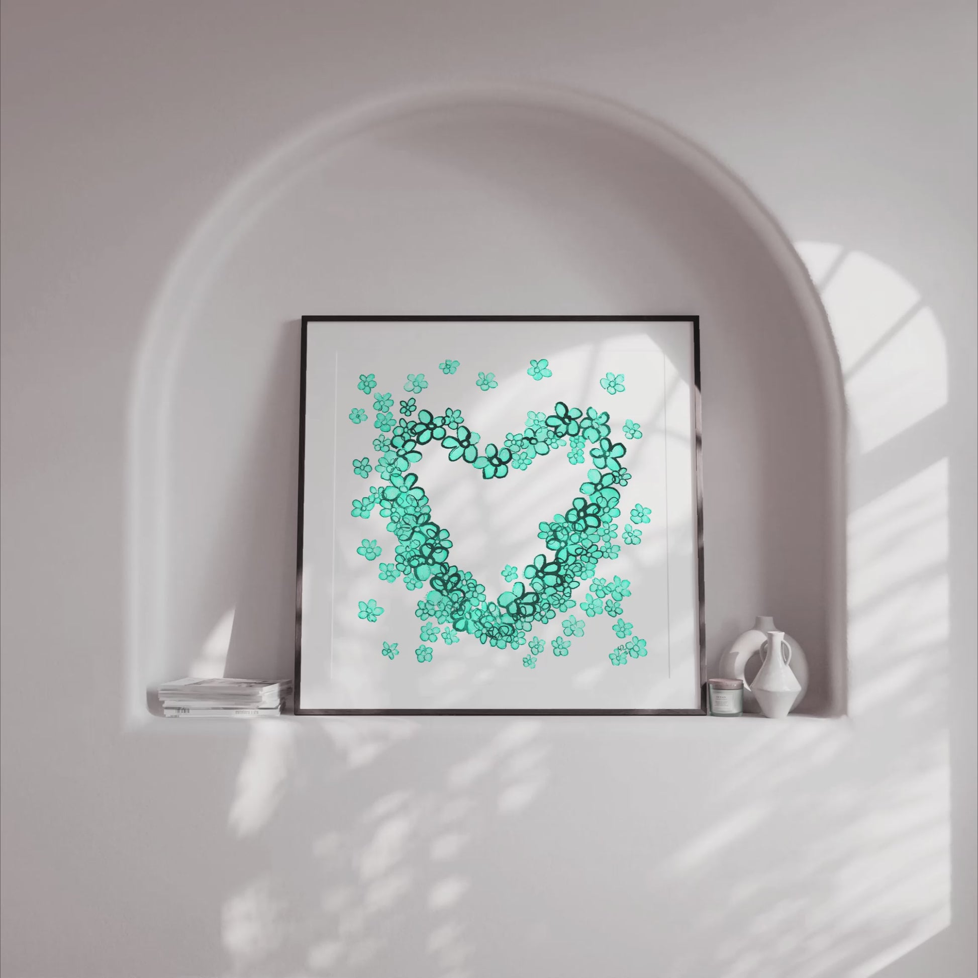 Video showing framed art print of Teal Floral Heart - a delicate painting by Susan Marie Williams of a heart shape composed of teal flowers - in a light alcove with gently moving shadows